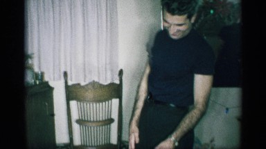 1959: a man laughing at his house for the gift opened gift of toy