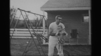 1959: Man Removes Son From Fence Before He Climbs Farther
