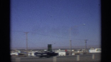 1959: view of road driving a car buy a man with his friends and it shows the day