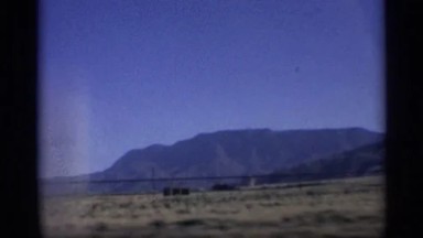 1959: the car slow drive in the road near to mountain tree wood green grasses