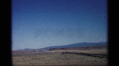 1959: a broad open place with some grass and plants the mountain