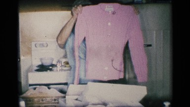 1959: an elderly woman holds a pink long sleeved shirt in the air NEW YORK