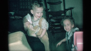 1959: two water headed toddlers are playing together in the front room