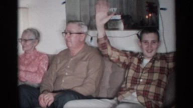 1959:family sitting on couch living room setup.