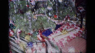 1959: a child beside presents under a christmas tree NEW YORK