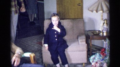 1959: Cute Little Boy in Blue Coat and Hat Removes Hat in New York