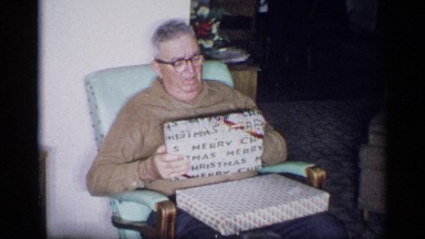 1959: three people are sitting at their house and a boy given gift boxes