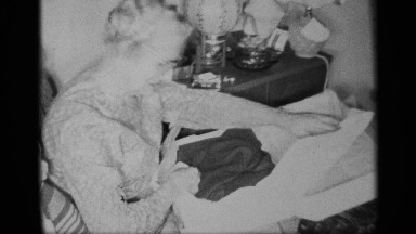 1959: the old lady look a bit of cloth and she smiles