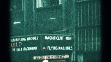 1959: banner area of a shop in a busy city day, people are talking