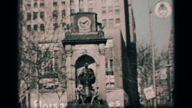 1959: a statue in front of a clock tower, and the view of a huge building
