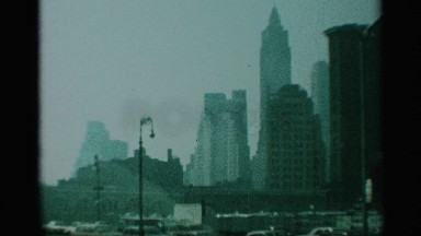 1959: long and sharp top edged buildings covered with bus running in road