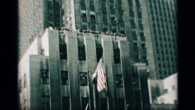 1959: people on top of a building with a flag. NEW YORK