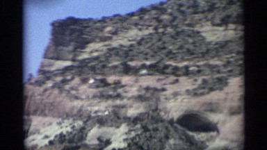 1959: an arid hilly area with many layers and bushy vegetation ARIZONA