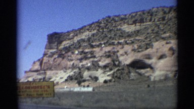 1959: the car run the slow near to name board and big mountain