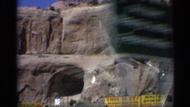 1959: the view of caves formed on a large rock on the roadside ARIZONA