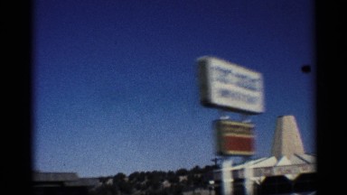 1959: driving along the highway and passing a red tow truck at a gas station