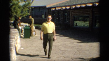 1959: a guy is thoroughly enjoying himself as he walks along a path greeting