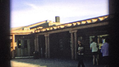 1959: people relaxing in the garden outside a small and pretty shopping mall