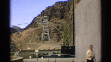 1959: a man at the construction area and walking with see the watch it