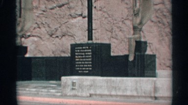 1959: gold words cover the face of a black shiny memorial placard ARIZONA