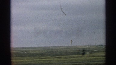 1959: a vehicle drives down a country road on a cloudy, stormy day ARIZONA