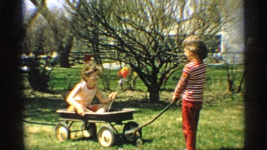 1959: kids are playing in backyard and having fun rolling over the holidays