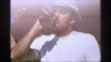 1959: father drinking a pbr beer outside his lawn with his two children playing