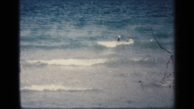 1959: the beach side bath the men and in the ocean morning time clear the view