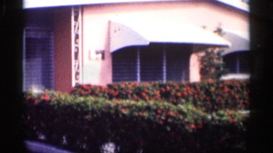 1959: the big building in rose color window door attach near big garden lamp