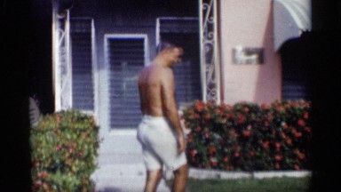 1959: man and boy horse around for the camera in the front yard CALIFORNIA