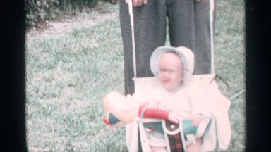 1959: middle aged father with his son in a beautiful garden