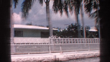 1959: apartments with entrance gate and trees also surrounding the apartments