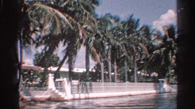 1959: River Slow Run One Side Green Grasses and Building Steps Morning Time