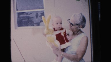 1959: a old women play in the walk our child hand take doll