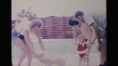 1959: some of the people play with dog and baby she carry the child