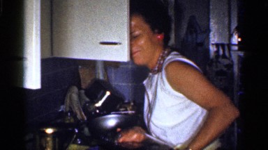 1959: women cooking and washing in kitchen around plays with her kid FLORIDA