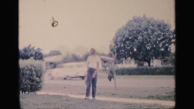 1959: a boy in a yard waving and gesturing FLORIDA
