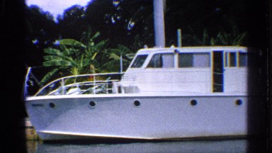 1959: a yacht sitting anchored by the shore of a tropical climate. FLORIDA