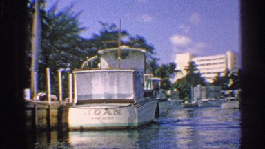 1959: a boat slow run in the harbor near stop the another boat water coconut