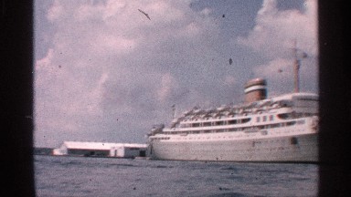 1959: Distant View of a Large Moored Cruise Ship Across the Water