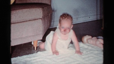 1959: Baby Attempting to Crawl on White Rug in Florida