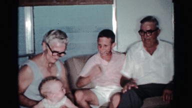 1959: child and baby are playing with their grand parents indoor fun moments.