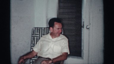 1959: 3 men carousing inside summer house at nighttime two of them smoking and