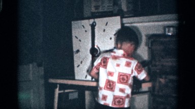 1959: a young boy in a colorful printed shirt is playing in a garage FLORIDA