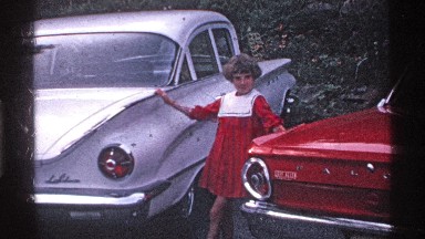 1969: A Girl Dances Between Two Classic Cars in Ohio