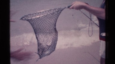 1973: the women catching fish on the fish net and it is fall down FLORIDA
