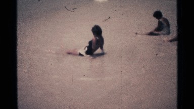 1973: ladies on their swimsuit resting on the waves of the beach. FLORIDA