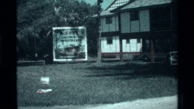 1973: big building in low angle view white color near green grasses tree name
