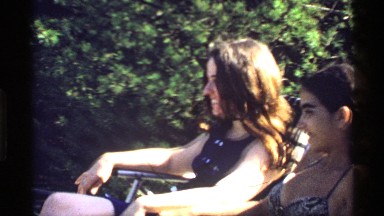 1978: two women sit in the place garden chair near tree green grasses dresses