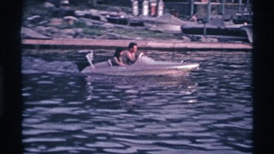 1969: Man and Woman Take a Ride in Their New Boat Across the Water